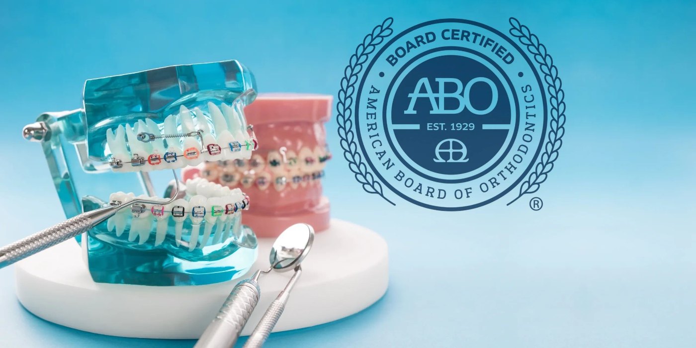 American Board of Orthodontics board-certified seal next to a dental model with braces at Bar Orthodontics